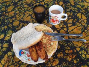 Breakfast at hotel - plantain, omelette, fresh mango and pineapple juice