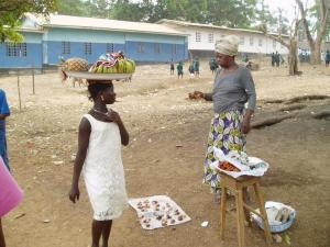 Selling pineapple and plantain at a school