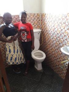 Paul school - These girls were happy to show us their new toilets in the girls' dormitory block.